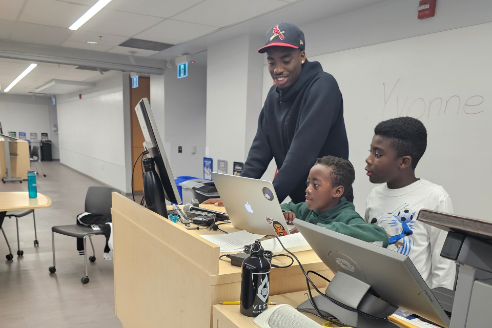 Student getting mentored by a Black Youth in STEM employee